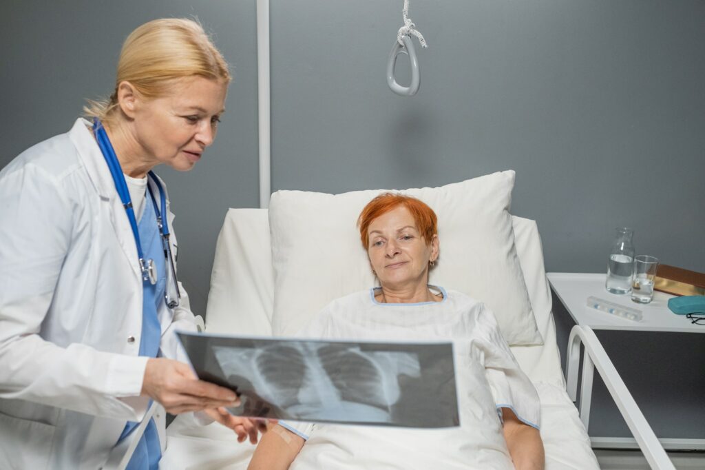 Doctor showing the x-ray image to elderly woman